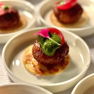 Our signature Lamb Galouti Kebab. This melt-in-your-mouth delicacy is a modern tribute to the royal kitchens of Awadh, and a must-try at our events.