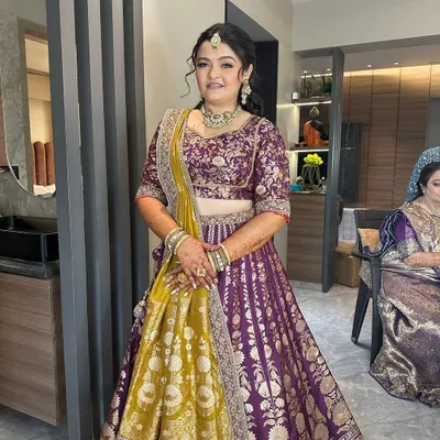 A full view of this beautiful hairstyle. The half-updo is adorned with a statement hair accessory, and the rest of the hair is styled in loose waves, perfect for a wedding or reception.