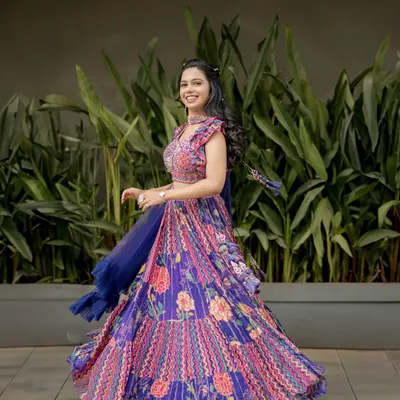 A joyful shot of the bride twirling in her vibrant sangeet lehenga. This photo is full of life, color, and movement.