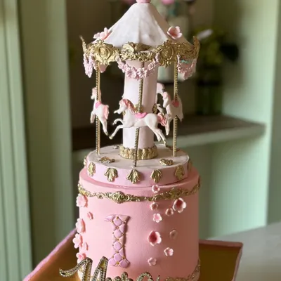 A fairytale on a cake stand. Our carousel cakes, like this one for a first birthday, are a spinning delight of sweetness and sparkle, featuring handcrafted horses and intricate details.