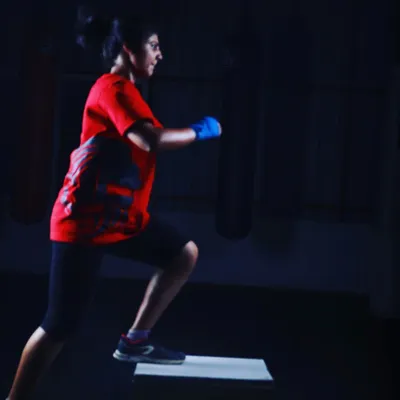 A member performs a step-up, a foundational exercise in our conditioning programs to build lower body strength and cardiovascular endurance.