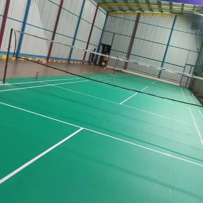 A clear view of one of our professional-grade indoor badminton courts. The space is well-lit with high ceilings and proper flooring, ready for training and matches.