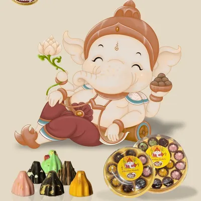 Celebrate Ganesh Chaturthi with our Chocolate Modak Collection. This promotional image showcases our variety of flavors and festive packaging, perfect for prasad and gifting.