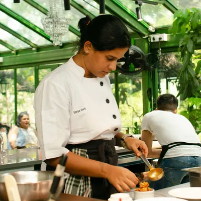 Chef Shriya Shetty plating a dish during her 'Thindi' pop-up. She brought us a Mangalorean breakfast spread filled with nostalgia and tradition, where every dish told a story of her childhood.