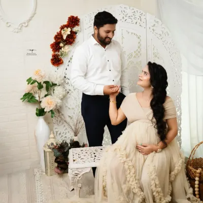 A beautiful moment between the expecting couple in my boho setup. The soft, neutral tones and natural textures create a warm and inviting atmosphere.
