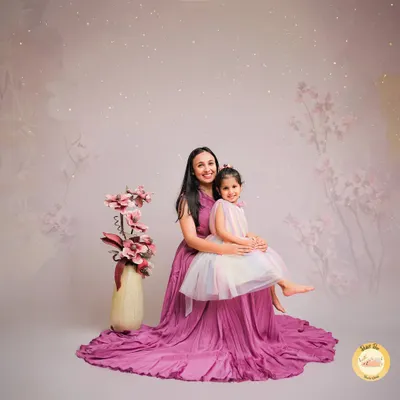 A magical mother-daughter portrait with a dreamy, whimsical theme. The matching gowns and the soft, starry background create a beautiful, storybook feel for this special bond.