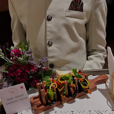 A modern twist on a classic flavor. Our Ghee Roast Chicken Tacos are served in charcoal shells, offering a unique and flavorful bite that represents our innovative approach to Indian cuisine.