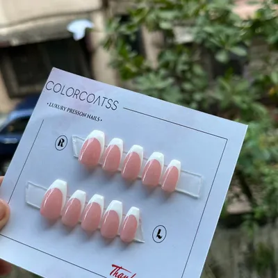 The quintessential classic French manicure. This custom press-on set features a clean, crisp white tip on a natural pink base, shaped into a sophisticated medium coffin style.