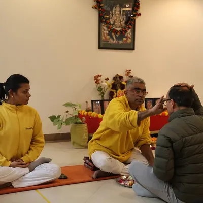 I perform the initiation ceremony, or Diksha, for a new student in our Yoga Teachers' Training Course. This ritual marks the formal beginning of their journey within our Guru-Sishya tradition.