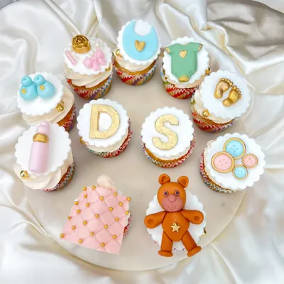 Welcoming a little one is such a special time. We created this set of custom baby shower cupcakes with adorable, handcrafted fondant toppers, including initials, teddy bears, booties, and baby bottles.