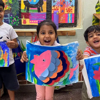 The excitement of showing off your creation is the best part of class! These colorful paper fish were made by layering shapes, a great exercise in planning and coordination for our 3.5 to 5-year-old artists.