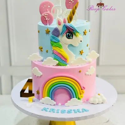 This two-tier unicorn cake is a showstopper for any child's birthday. The bottom tier features a pastel rainbow, while the top has a hand-sculpted unicorn, all made with delicious whipped cream frosting.