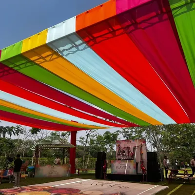 A vibrant canopy of colorful drapes set the stage for a massive Holi celebration at the JW Marriott Golfshire.