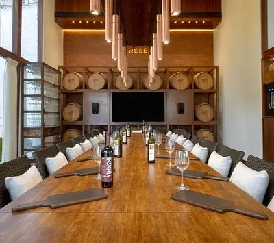 Welcome to the 'Cave de la Reserve' at my Grover Zampa Experience Centre. This private tasting room, with its long wooden table and backdrop of wine barrels, is the perfect setting for an exclusive and intimate gathering.