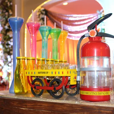 Why settle for ordinary sips? We bring the fun with unique serving methods like this shot cart, fire extinguisher dispenser, and colorful yard glasses.