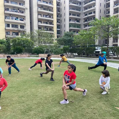 We also conduct outdoor fitness classes in residential communities like RPS Savana Society in Sector 88. It is a great way for kids to get active and build strength together.