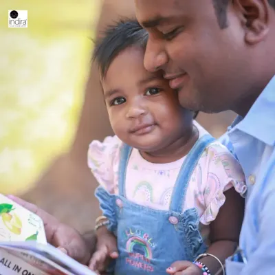 A father and daughter sharing a quiet moment reading a book together. This is the kind of authentic, love-filled interaction I aim to capture in my lifestyle family sessions.