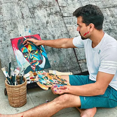 Here I am getting lost in the process of painting a colorful portrait. You can see the focus and joy that comes with applying paint to canvas, a feeling I hope to share with every student in my art classes.