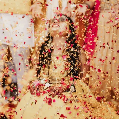 A moment of pure bliss as the bride is showered in flower petals during her Haldi ceremony. I use lighting to make the colors pop and capture the festive atmosphere.