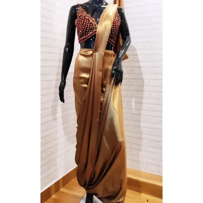 This custom dhoti-style draped saree in gold satin, paired with an embroidered blouse, is a signature example of my fusion wear. It offers the grace of a saree with the comfort and edge of a modern silhouette, all tailored for a perfect fit.