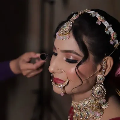 A behind-the-scenes moment of applying the perfect winged eyeliner. This is a crucial step for defining the eyes.