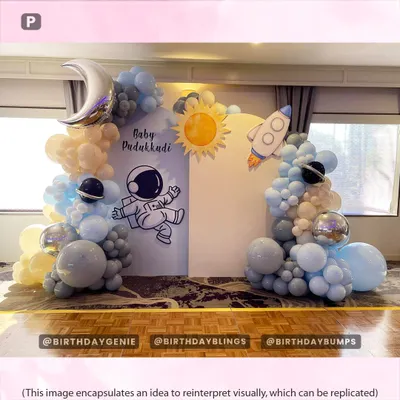 A gentle and dreamy "Baby's First Trip Around the Sun" space theme, using soft pastel blue and cream balloons with moon and rocket accents.