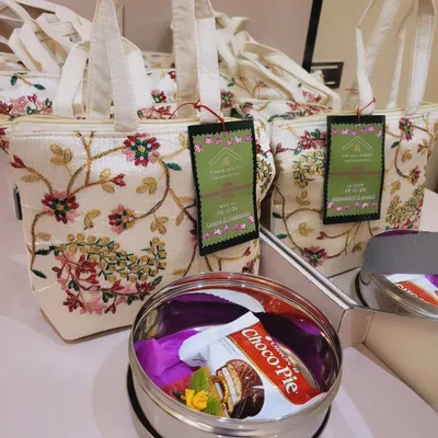 These beautiful hand-embroidered bags are a popular choice for gruhapravesha and mehandi return favors. They are spacious enough to hold multiple gift items.