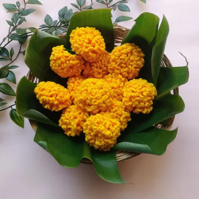 A basket of my handmade crochet marigolds (genda phool), looking just like they were freshly picked. These are perfect for offering during pooja or for decoration.