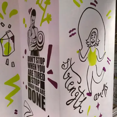 "Don't stop when you are tired, stop when you are done." This motivational doodle art for a gym in Bandra combines inspiring quotes with fun fitness-related illustrations like a skipping girl.