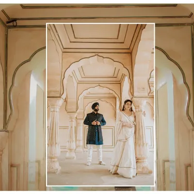 A majestic portrait set within the ornate corridors of a Jaipur palace, capturing a sense of royal grandeur and timeless love for this Sikh couple's pre-wedding shoot.