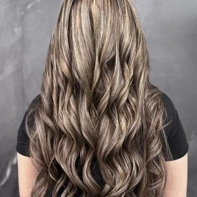 When rich brunette meets soft blonde highlights, the result is this voluminous, high-contrast look that is pure hair envy.