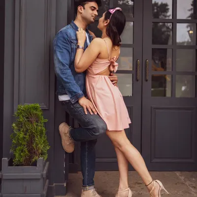 A stylish and modern couple portrait against a dark, elegant doorway. This shot highlights a chic, urban vibe that we can create within our studio's versatile sets.
