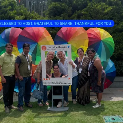 Blessed to host, grateful to share. A moment with our team and visitors at the Monsoon Collective, surrounded by the colourful energy that defines our events.
