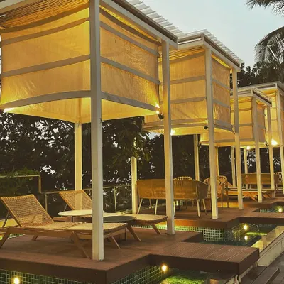 For the outdoor lounge at Mirage, Goa, the lighting was designed to create a warm, tranquil escape. The illuminated canopies of the cabanas and the subtle uplights in the surrounding water work together to produce a beautiful, relaxing atmosphere perfect for a resort setting.