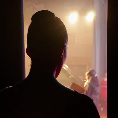 The moment just before stepping on stage. Standing in the wings, heart racing, every muscle ready. This is the quiet anticipation before the performance begins.