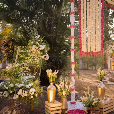 Our team setting up the entrance decor, ensuring the custom mirror sign and floral arrangements are perfectly placed to welcome guests.