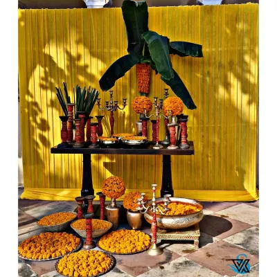 This is a classic Haldi setup I created, featuring a bright yellow backdrop that makes the colors pop. The arrangement includes a traditional table with brass candelabras, marigold spheres, and bowls of fresh petals, ready for the ceremony.