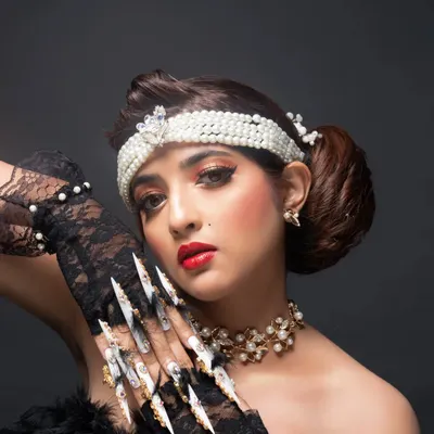 A look at the fantasy nail art I created for a makeup artist's beauty competition. The retro look included these extra-long stiletto nails with heavy jewelry and feather accents.