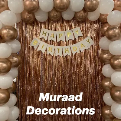 A simple yet classic balloon frame against a rose gold fringe curtain. The white and chrome copper balloons create an elegant photo booth for any celebration.