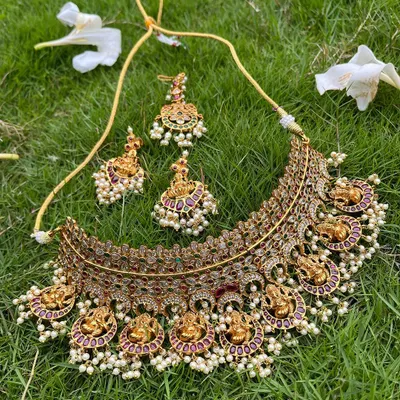 A beautiful antique-finish choker with Lakshmi motifs and pearl drops. This piece can be rented on its own or paired with a longer necklace.