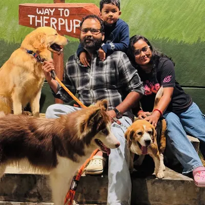 A beautiful family portrait with their three dogs. This is what we mean by a new-age family, where pets are cherished members.