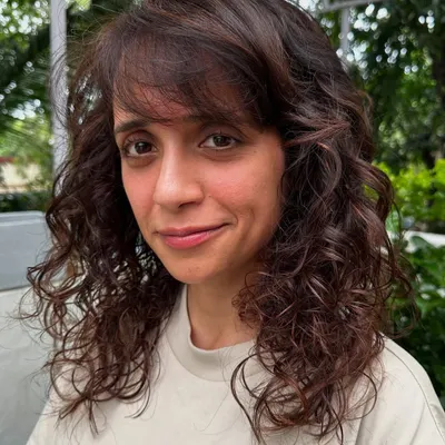 Curly and proud. I gave her curls a new life with a fresh cut, including a fringe, and subtle reddish-brown highlights to define the texture. Embracing your natural curls is always a good idea.