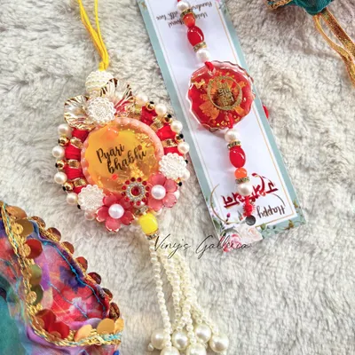 This Raksha Bandhan, gift your brother and bhabhi a one-of-a-kind rakhi set. This beautiful lumba for your "Pyari Bhabhi" is purely handcrafted, with no copies, just like your special bond.