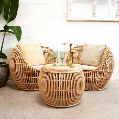 This cozy seating arrangement features our deep, rounded rattan armchairs and a matching drum-style coffee table. The natural finish and comfortable design make this set perfect for a relaxed living room or a sheltered patio space.