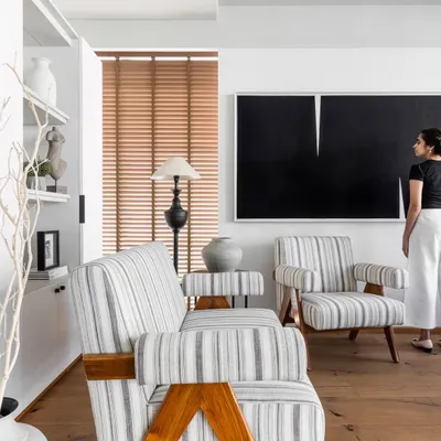 The Director's Cabin is a blend of contemporary luxury and calming sophistication. Here, I am seen contemplating the space, which features high-end materials, neutral tones, and a custom-made artwork to create an environment that is both inspiring and professional.