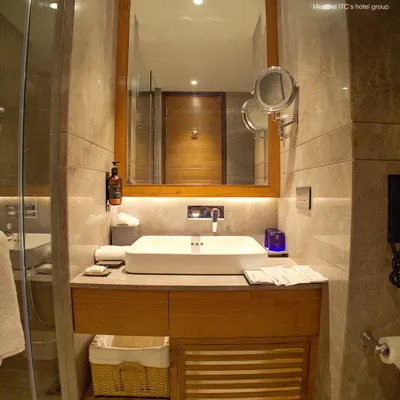 Our bathrooms are designed for function and comfort. They feature a clean, modern vanity with a large mirror, excellent lighting, and a magnifying mirror for your convenience.