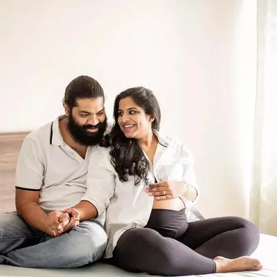 An in-home maternity session is perfect for capturing your real life. This couple shared a sweet, relaxed moment on their bed, just being themselves.