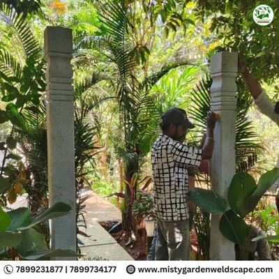 Our team carefully installing heavy, natural stone pillars for an archway at a farmhouse. This traditional feature adds a sense of timeless elegance to the landscape.