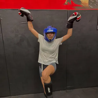 You are a warrior, a fighter, a force of nature. This is one of our female fighters, fully geared up and celebrating her strength. We train women to be fierce and unstoppable.