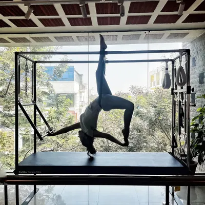 Finding balance in every breath, sculpting strength with grace. This pose on the Cadillac requires full-body integration, from the core to the limbs, to create this beautiful, suspended shape.